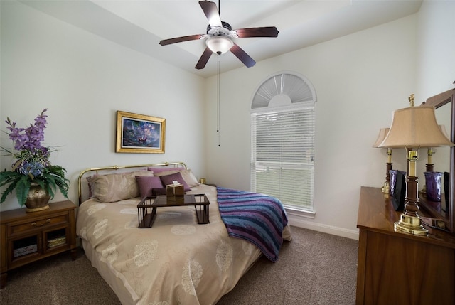 carpeted bedroom featuring baseboards and a ceiling fan
