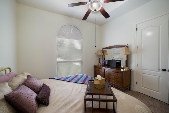 bedroom featuring light carpet and a ceiling fan