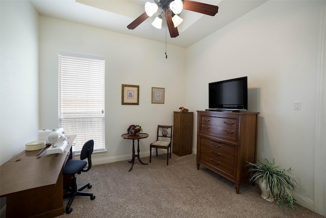 office with a ceiling fan, baseboards, and light colored carpet