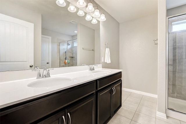 bathroom with baseboards, a sink, tile patterned floors, and a shower stall