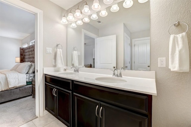 bathroom with tile patterned floors, visible vents, a sink, and ensuite bath