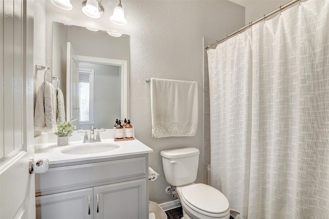 full bathroom with toilet, a textured wall, a shower with shower curtain, and vanity