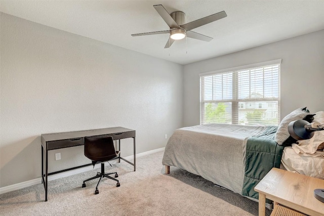 carpeted bedroom featuring baseboards and ceiling fan