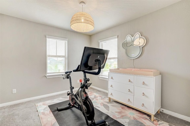 workout room featuring baseboards and carpet