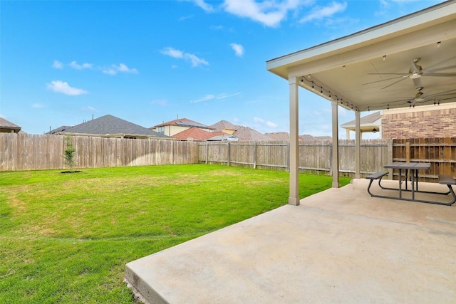 view of yard featuring a fenced backyard, ceiling fan, and a patio area
