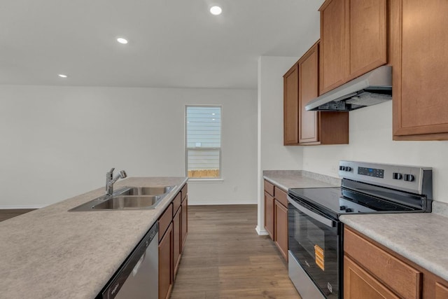 201 Lucky Texan Rd, Jarrell, TX 76537 - kitchen featuring stainless steel appliances, under cabinet range hood, wood finished floors, light countertops, and recessed lighting