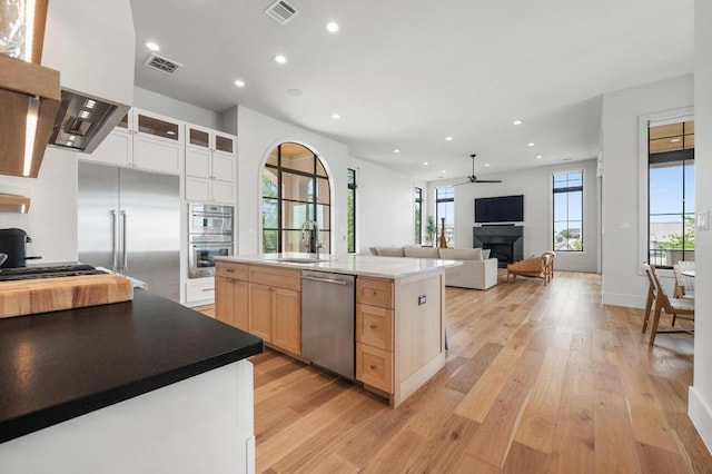 kitchen featuring visible vents, ceiling fan, appliances with stainless steel finishes, and light wood finished floors