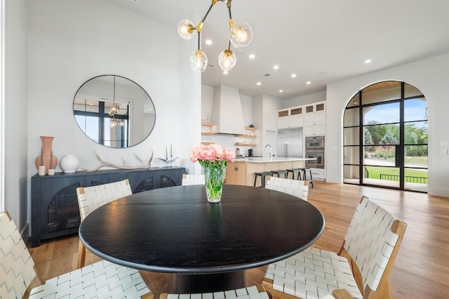 dining space featuring recessed lighting and light wood finished floors