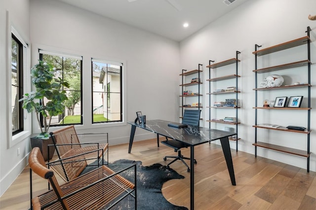 home office with recessed lighting, baseboards, visible vents, and light wood-type flooring