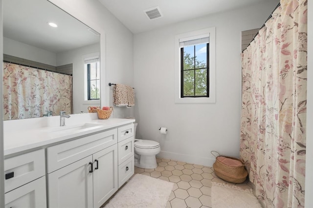 bathroom with visible vents, tile patterned flooring, vanity, toilet, and baseboards