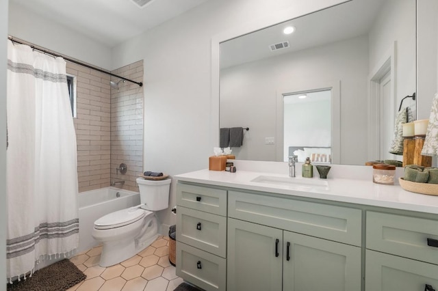 bathroom featuring vanity, visible vents, toilet, tile patterned floors, and shower / tub combo