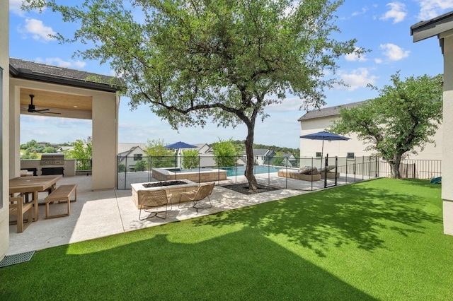 view of yard featuring fence, a fenced in pool, a patio area, exterior kitchen, and visible vents