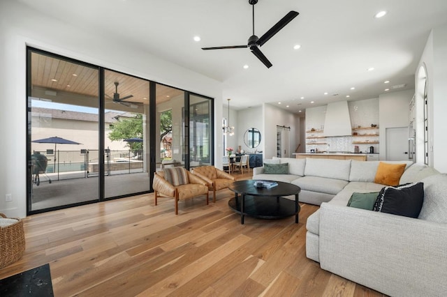 living room with light wood-style floors, ceiling fan, and recessed lighting
