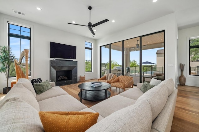 living room featuring ceiling fan, recessed lighting, and visible vents