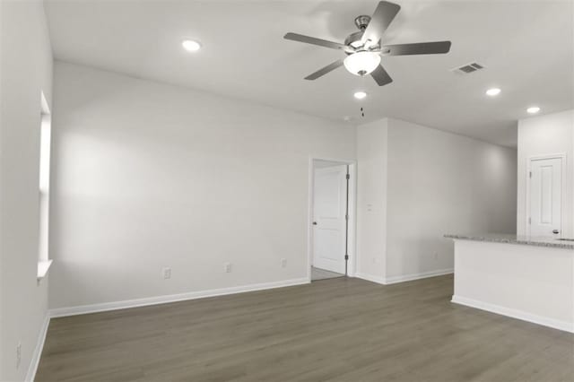 unfurnished living room with baseboards, a ceiling fan, and dark wood finished floors