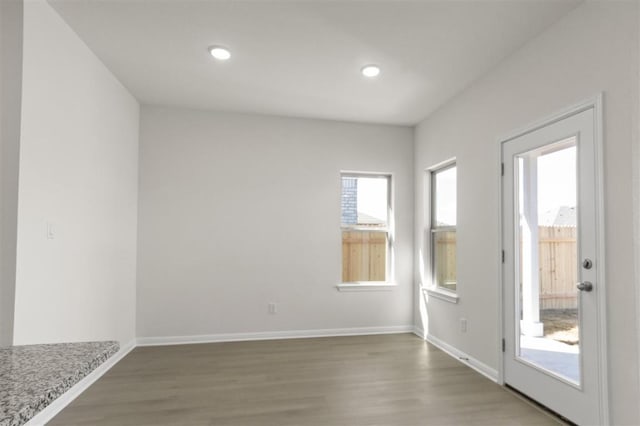 interior space with recessed lighting, baseboards, and wood finished floors