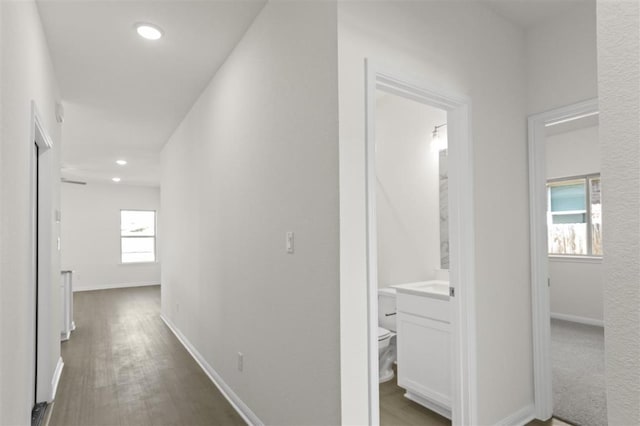 hall with recessed lighting, baseboards, and wood finished floors