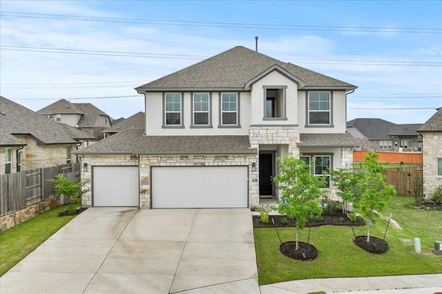 476 Wild Pecan Loop, Buda, TX 78610 - view of front facade with roof with shingles, driveway, stone siding, and stucco siding