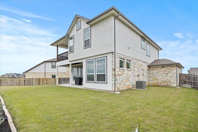 476 Wild Pecan Loop, Buda, TX 78610 - back of property featuring a balcony, stone siding, stucco siding, and a patio area