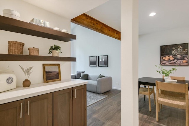 interior space featuring baseboards, beamed ceiling, recessed lighting, and wood finished floors