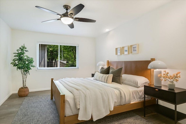 bedroom featuring baseboards, a ceiling fan, and wood finished floors