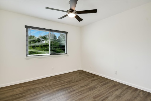 spare room with baseboards, a ceiling fan, and wood finished floors