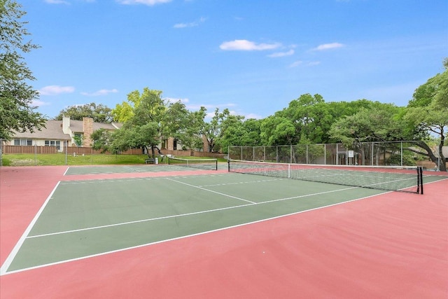 view of tennis court with fence and community basketball court