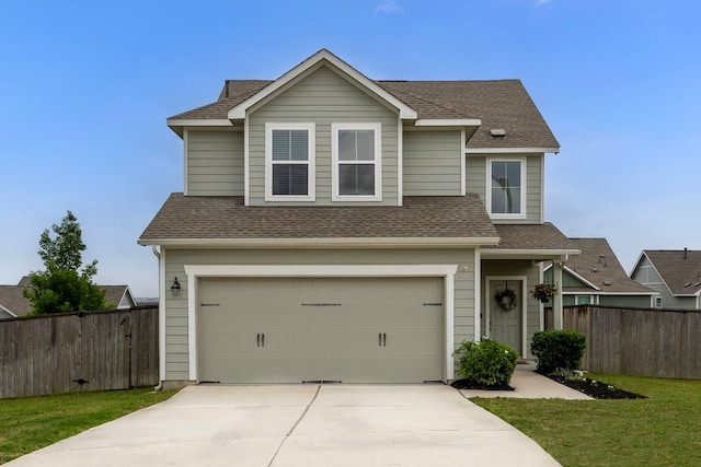 traditional-style house with fence, an attached garage, concrete driveway, and a shingled roof