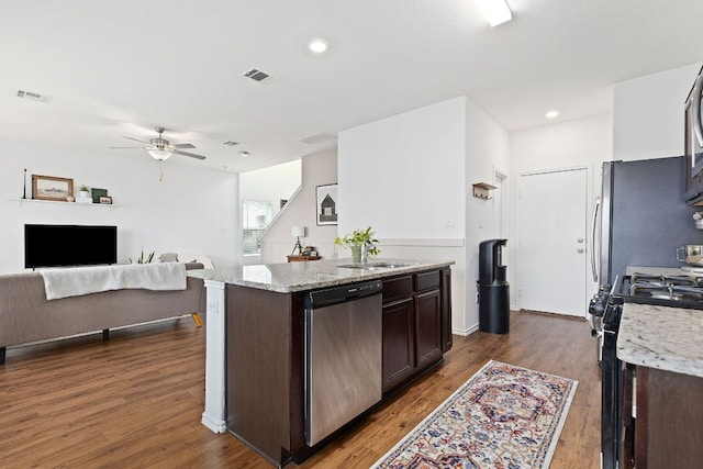 kitchen with visible vents, a ceiling fan, dark brown cabinets, a sink, and appliances with stainless steel finishes