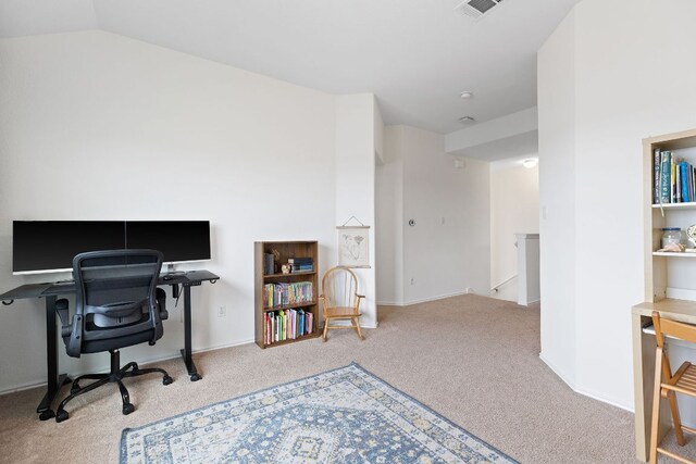 carpeted office with lofted ceiling and visible vents