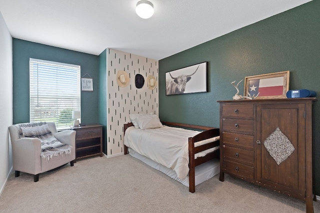 bedroom with baseboards and light carpet