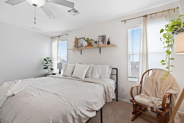 carpeted bedroom with visible vents and a ceiling fan