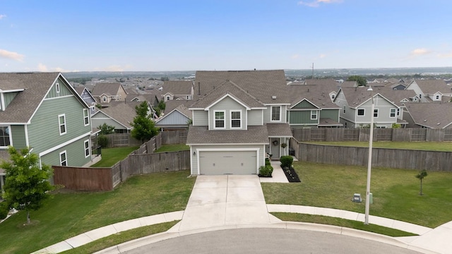 traditional-style home featuring a residential view, fence, an attached garage, and concrete driveway