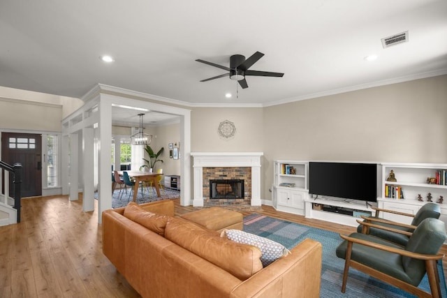 9417 Hopeland Dr, Austin, TX 78749 - living room with wood-type flooring, ceiling fan, a brick fireplace, recessed lighting, and ornamental molding