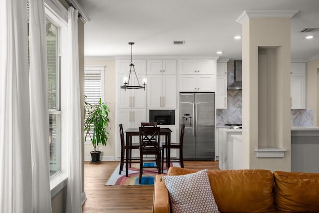9417 Hopeland Dr, Austin, TX 78749 - living room with ornamental molding, wood finished floors, recessed lighting, baseboards, and a chandelier
