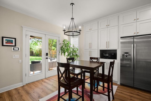 9417 Hopeland Dr, Austin, TX 78749 - dining area featuring a chandelier, wood finished floors, french doors, baseboards, and ornamental molding