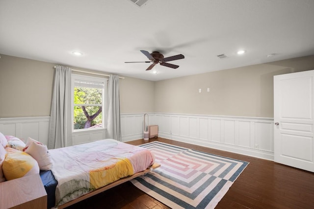 9417 Hopeland Dr, Austin, TX 78749 - bedroom featuring a wainscoted wall, dark wood-style floors, recessed lighting, a ceiling fan, and a decorative wall