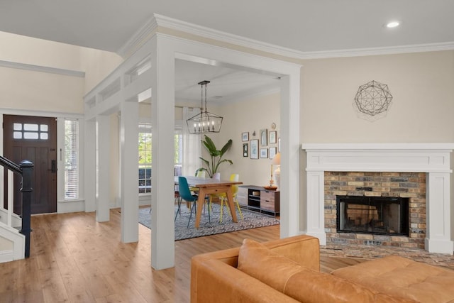 9417 Hopeland Dr, Austin, TX 78749 - living area featuring crown molding, light wood-type flooring, a chandelier, a brick fireplace, and recessed lighting