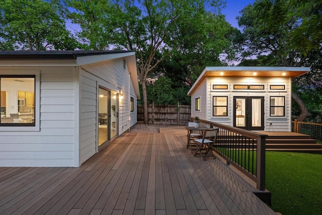deck with fence and an outbuilding