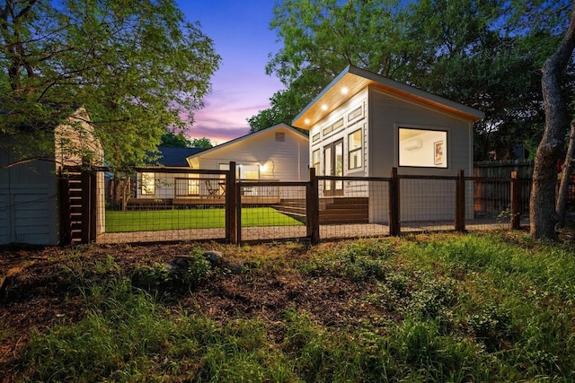 view of property exterior featuring a lawn and fence private yard