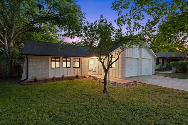 ranch-style house with brick siding, board and batten siding, a lawn, and concrete driveway