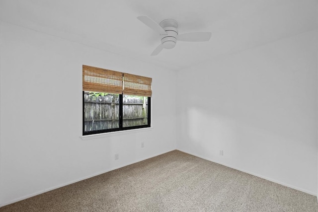 empty room with carpet floors, ceiling fan, and baseboards