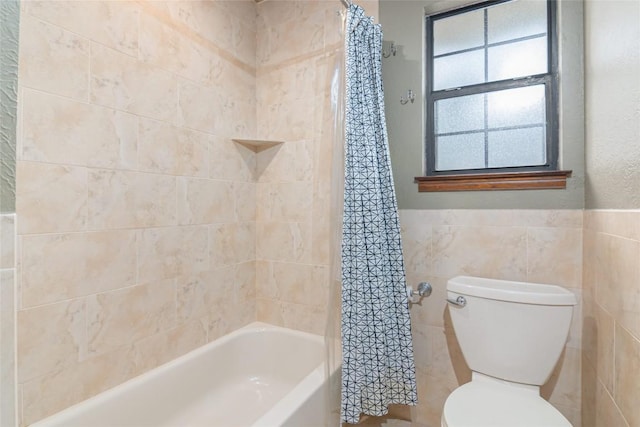 bathroom featuring shower / tub combo with curtain, toilet, and tile walls