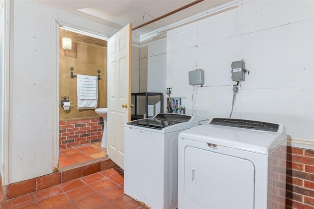 laundry room featuring washing machine and clothes dryer, laundry area, and tile patterned flooring