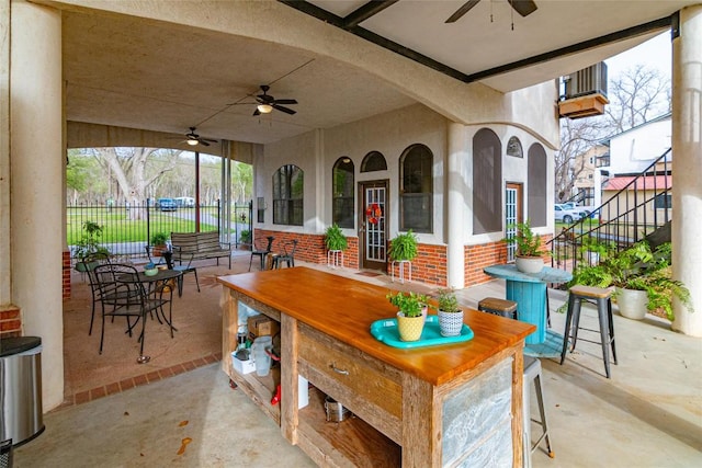 view of patio featuring fence and a ceiling fan