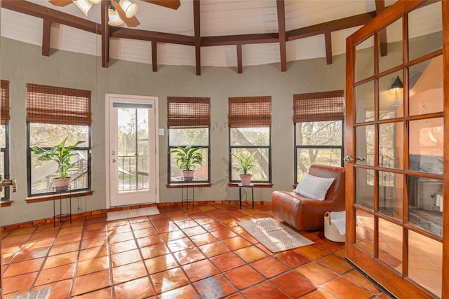 sunroom with baseboards, tile patterned floors, a healthy amount of sunlight, and vaulted ceiling with beams