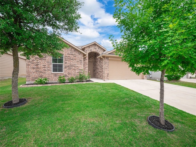 11904 Jamie Dr, Manor, TX 78653 - view of front of home featuring driveway, an attached garage, a front yard, and brick siding