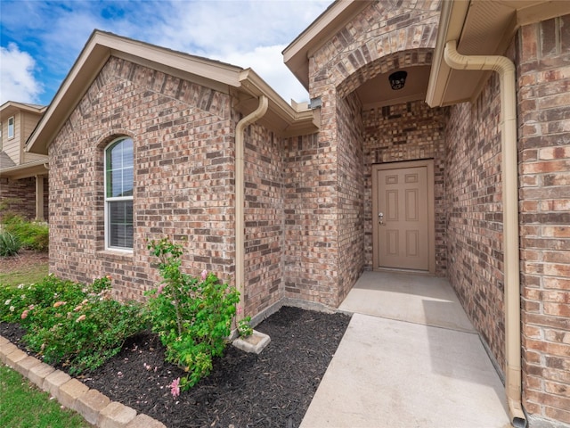 property entrance with brick siding