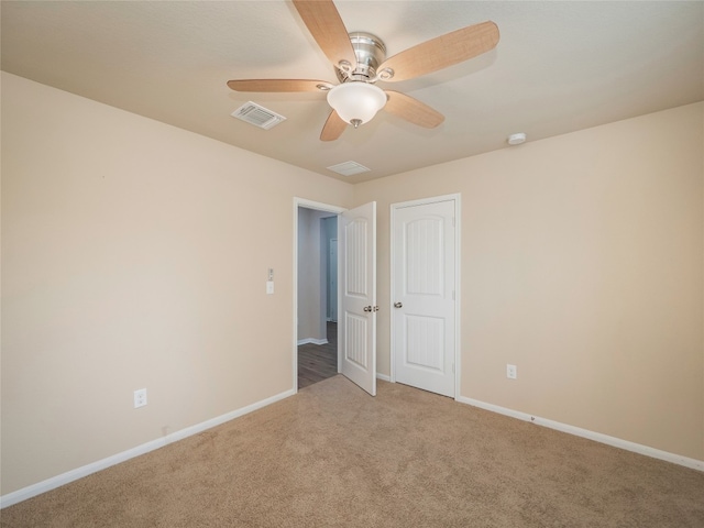 unfurnished bedroom featuring carpet floors, a ceiling fan, baseboards, and visible vents