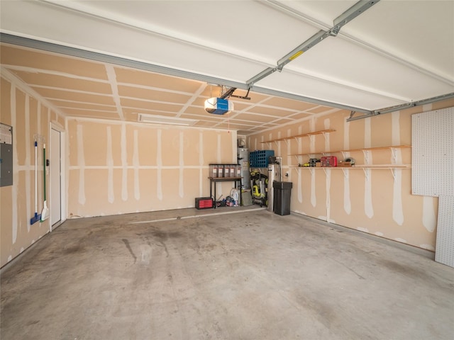 garage with water heater and a garage door opener